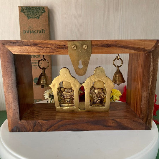 PujaCraft Brass Ganesha And Lakshmi Idol With Wooden Frame ( Width: 9cm, Height: 7cm, Weight: 405 Grams )